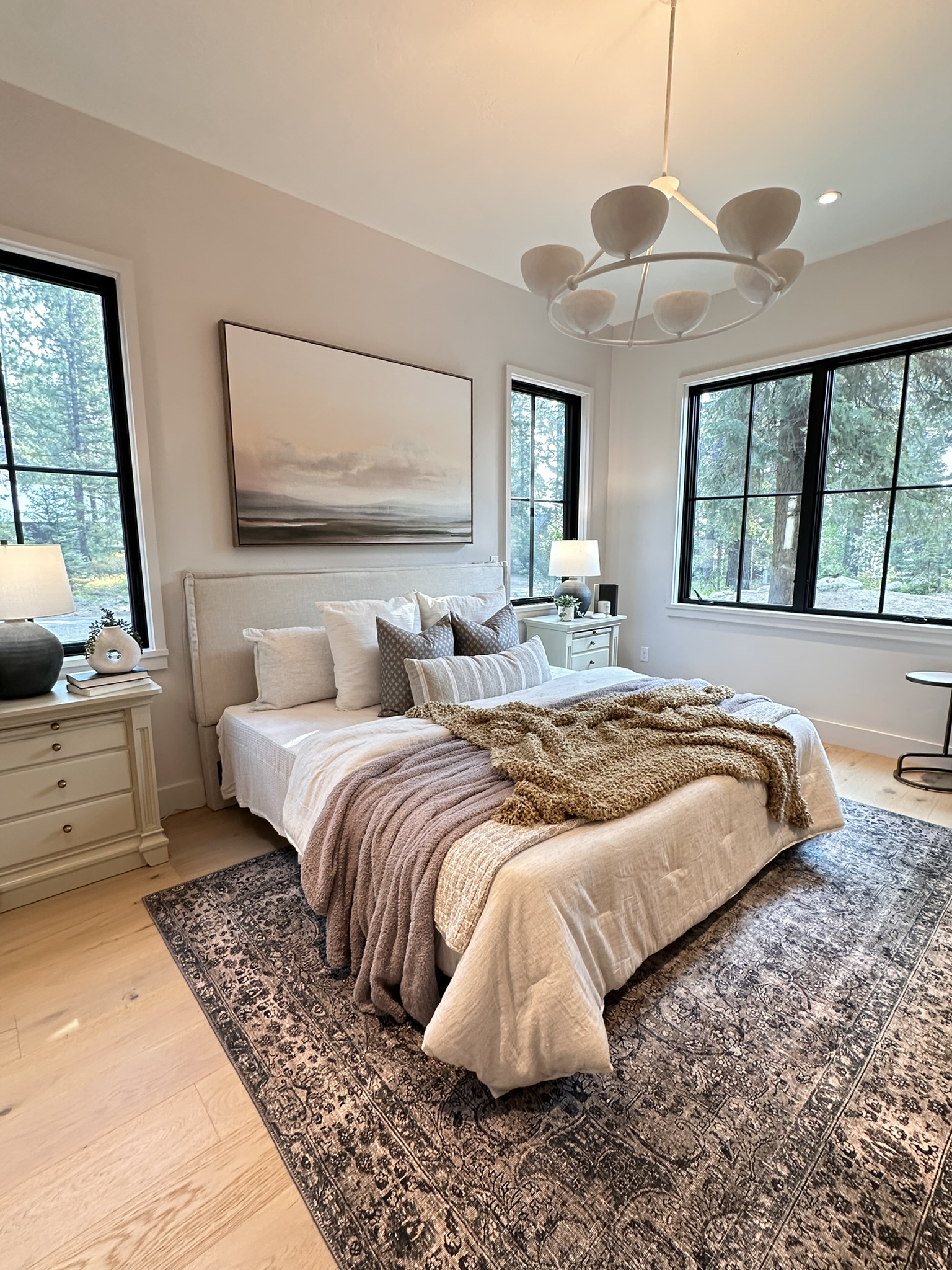 Luxury McCall, Idaho home interior — serene bedroom with forest views, neutral tones, and natural textures — featured in Realtor® Ragan Erickson’s blog on using AI to grow her real estate business.