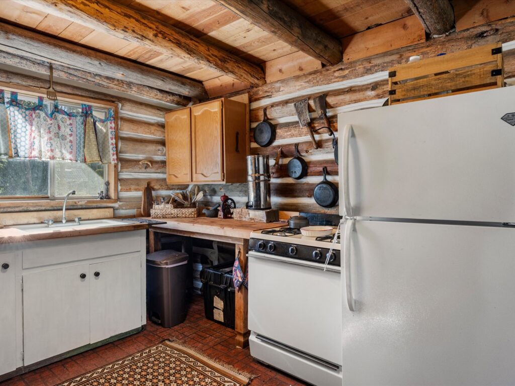 Cabin kitchen with a full-size refrigerator, gas range and butcher-block counters