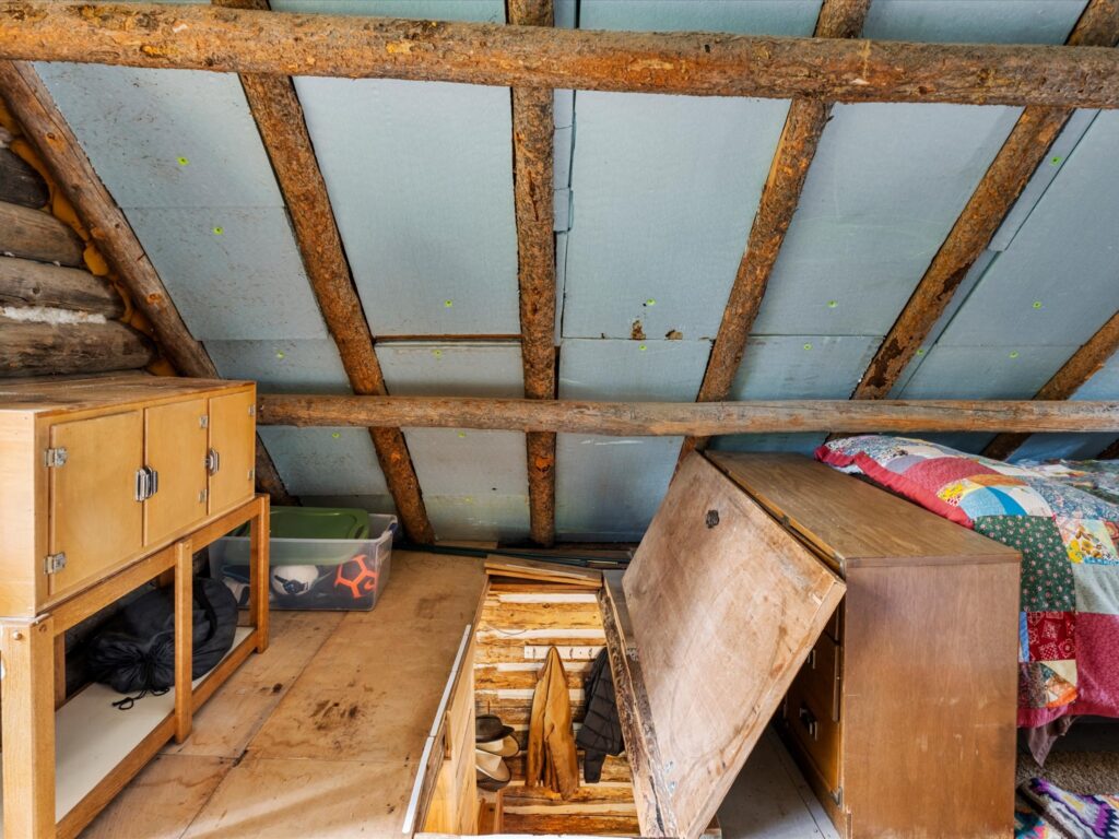 Built-in cabinets and storage under the eaves in the cabin loft