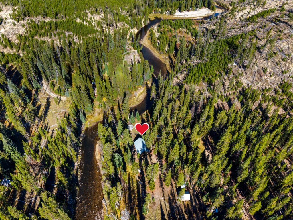 Aerial view looking upstream as the Secesh River winds past the cabin, marked with a heart