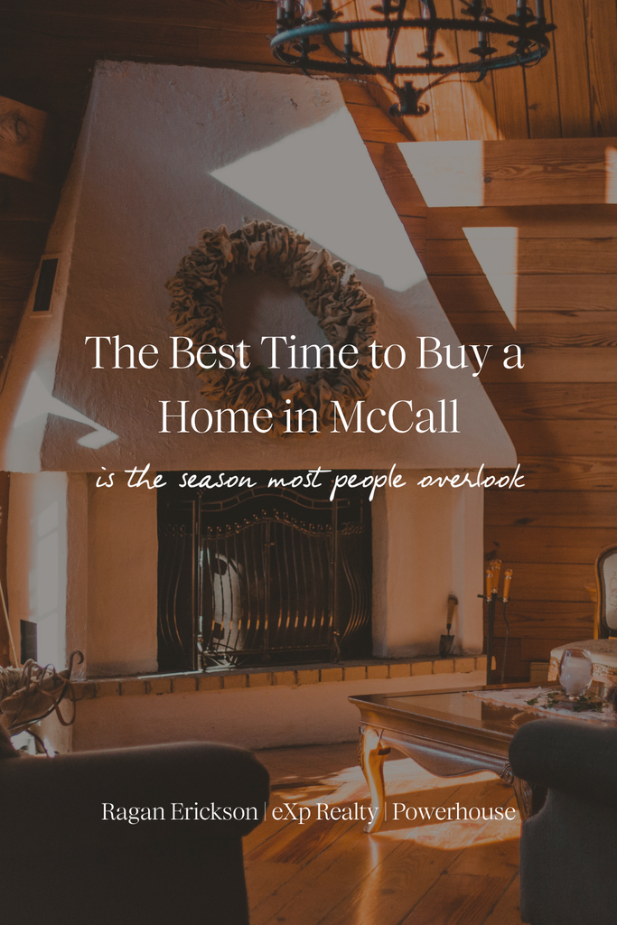 Cozy cabin living room with warm wood-paneled walls, a white plaster fireplace with an ornate iron screen and a burlap wreath, and an iron chandelier overhead. Text reads: “The Best Time to Buy a Home in McCall is the season most people overlook.” Ragan Erickson | eXp Realty | Powerhouse.